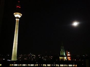 Low angle view of illuminated tower at night