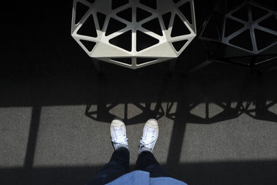 Low section of man standing on tiled floor