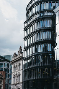 Low angle view of building against cloudy sky