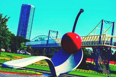 Metallic structure in city against clear sky