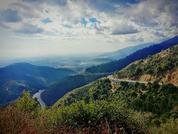 Scenic view of landscape against cloudy sky