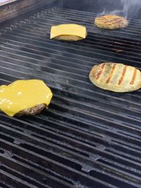 High angle view of yellow meat on barbecue grill