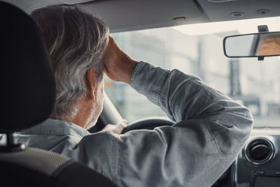 Senior man driving car