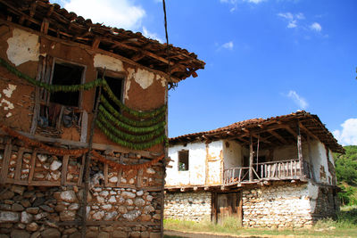 Low angle view of abandoned building against sky