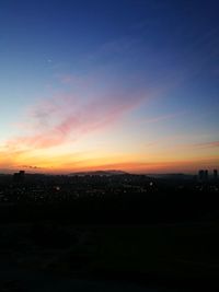 Silhouette cityscape against sky during sunset