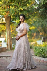 Full length of woman standing against tree