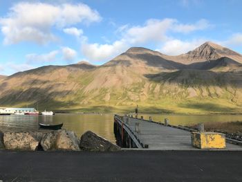 Scenic view of dam and mountains against sky