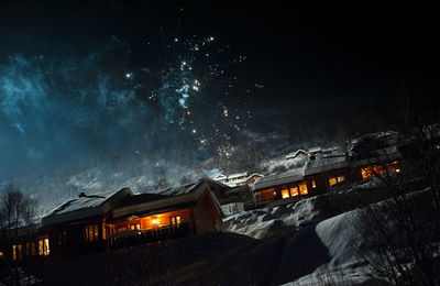 Sky over illuminated buildings at night