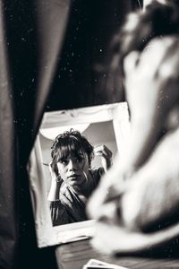 Woman looking in mirror at home