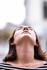 Portrait of young woman looking up