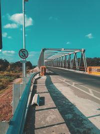 Bridge over road against sky