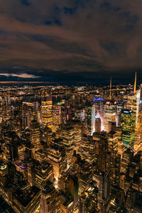 High angle view of illuminated cityscape against sky during sunset