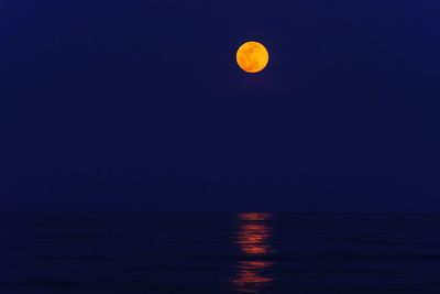 Scenic view of sea against clear sky at night