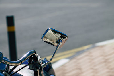 Close-up of motorcycle by road