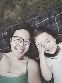 Portrait of a smiling woman and girl lying down