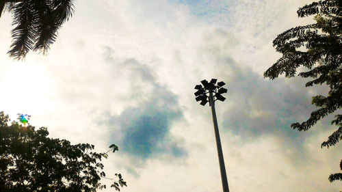 Low angle view of silhouette palm trees against sky