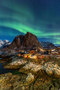 Scenic view of illuminated mountain against sky at night