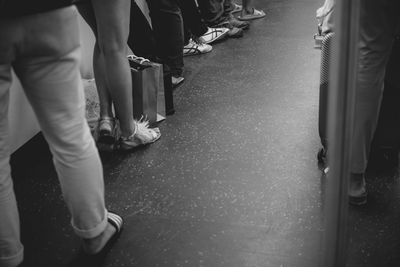 Low section of people walking on street