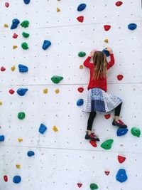 Rear view of girl on climbing wall