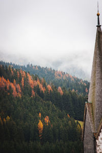 Scenic view of trees and mountains against sky during autumn