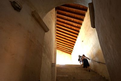 Rear view of woman walking in corridor