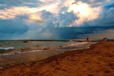 Scenic view of beach against sky during sunset