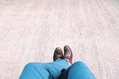 Low section of man sitting with legs crossed