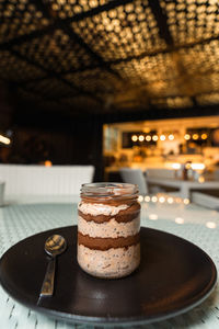 Delicious chocolate mousse or pudding with whipped cream in a vintage glass jar