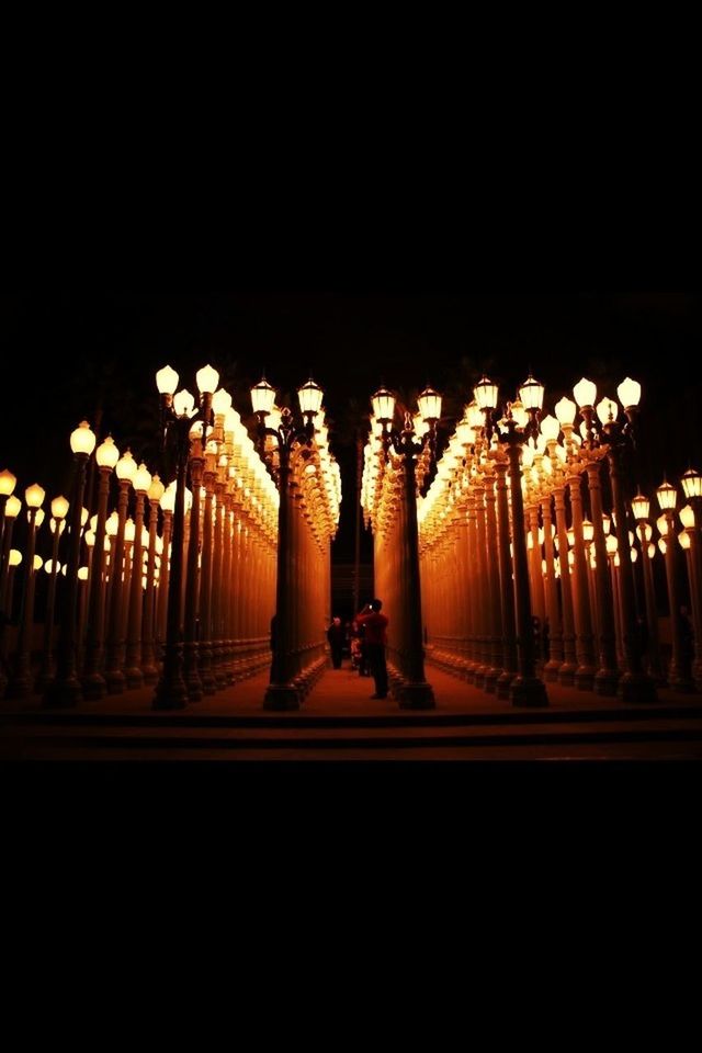 illuminated, in a row, night, lighting equipment, silhouette, side by side, copy space, indoors, architectural column, street light, statue, sculpture, clear sky, the way forward, sky, light - natural phenomenon, art, dark, diminishing perspective