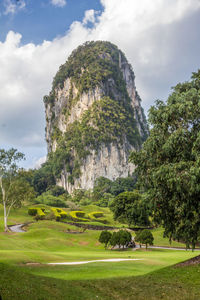 Scenic view of golf course against sky