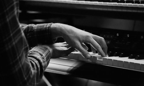 Close-up of man playing piano