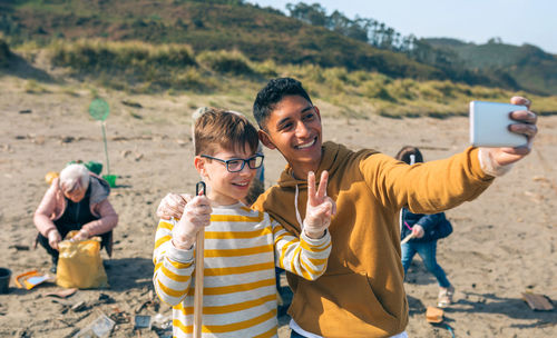 Portrait of smiling young couple on beach