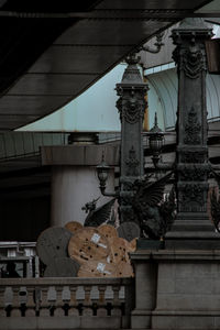 Low angle view of statue against building in city