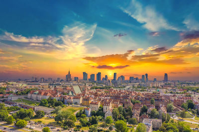 Aerial panorama of warsaw, poland over the vistual river and city center in a distance. sunset sky