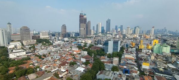 High angle view of buildings in city against sky