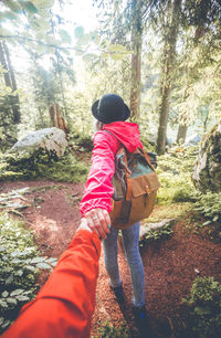 Rear view of man and woman in forest