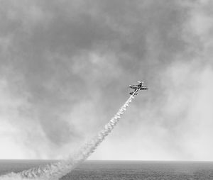 Low angle view of airplane flying in sky