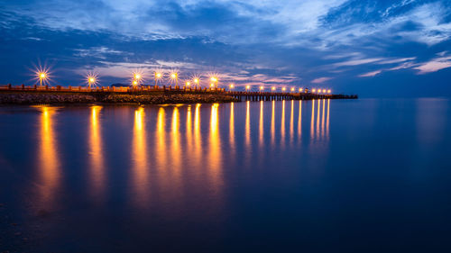 Illuminated pier at dusk