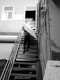 Low angle view of man walking on staircase of building