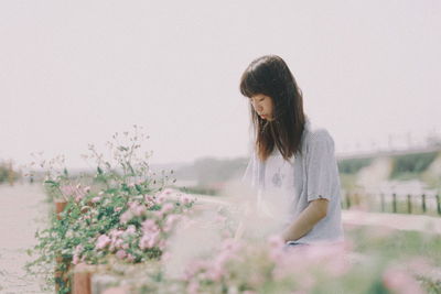 Woman sitting against sky