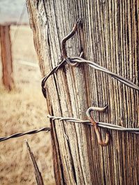 High angle view of metal tied on wooden fence