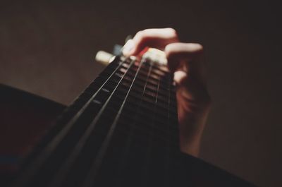 Close-up of hand playing guitar