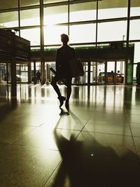 Full length of woman standing on railing