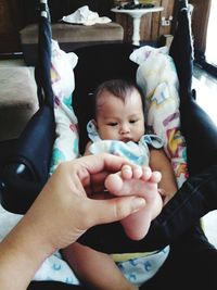 Cute baby girl sitting in bedroom