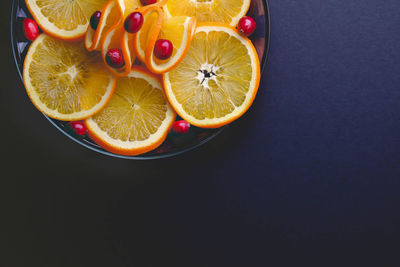 High angle view of orange on table against black background