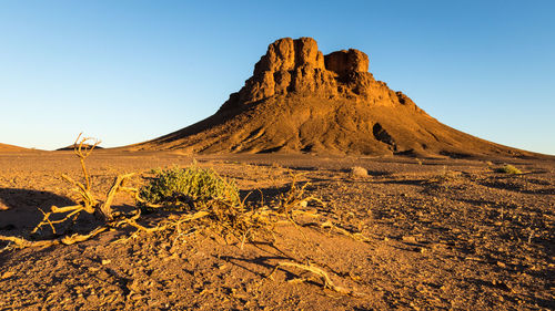 Scenic view of arid landscape against clear sky