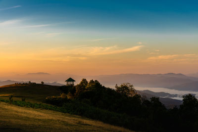 Scenic view of field against sky during sunset