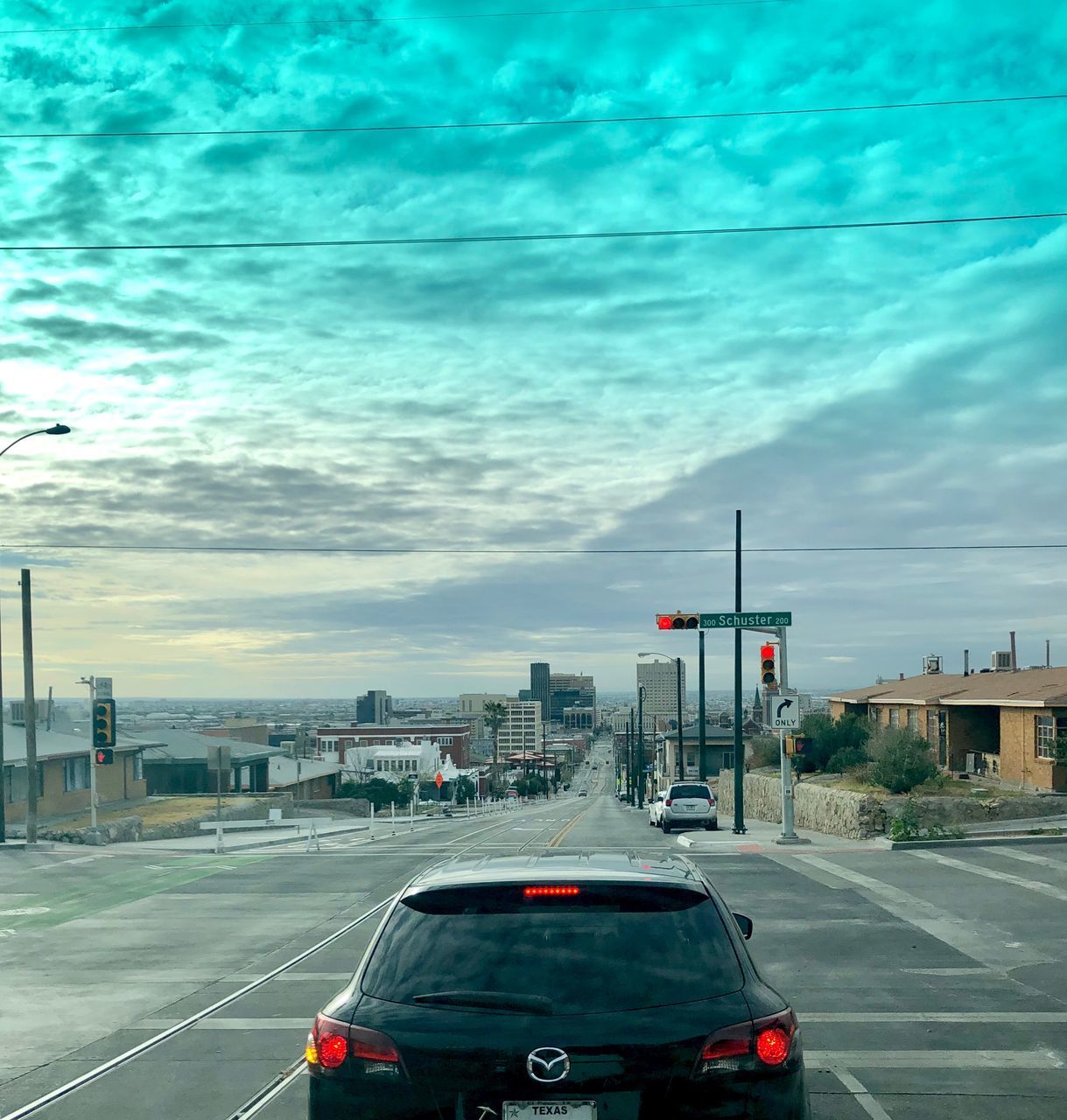 CARS ON ROAD AGAINST SKY IN CITY