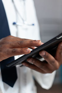 Midsection of man using mobile phone