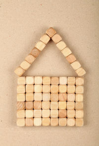 Directly above shot of wooden blocks arranged in house shape